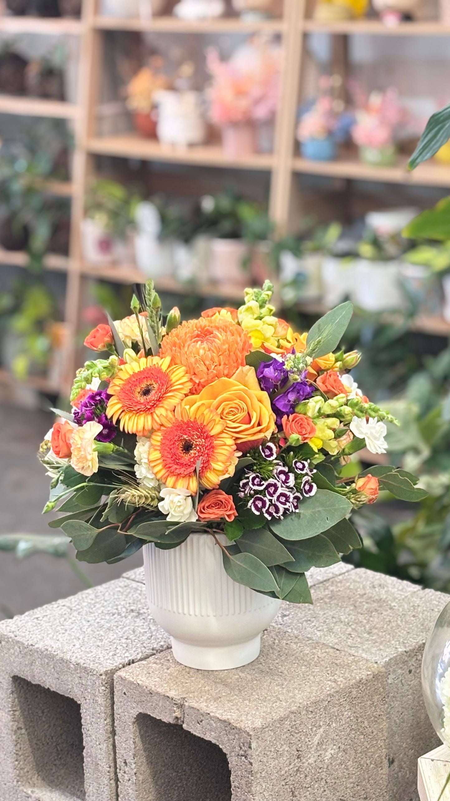 Mix summer floral arrangement in pot.